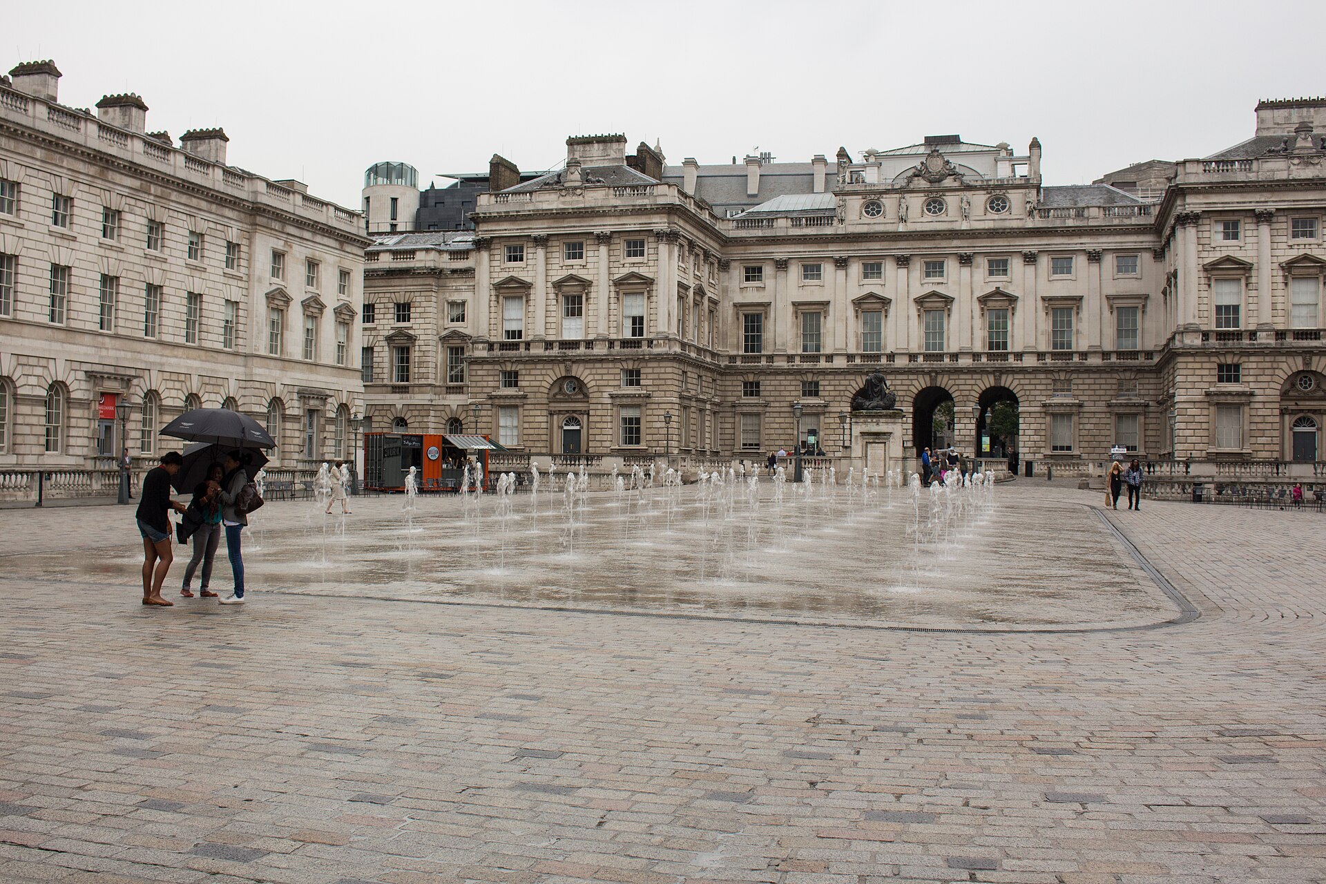 The courtyard of Somerset House, London. Archive photograph, 2014. Fountains and building facades; the 2026 exhibition is not pictured.